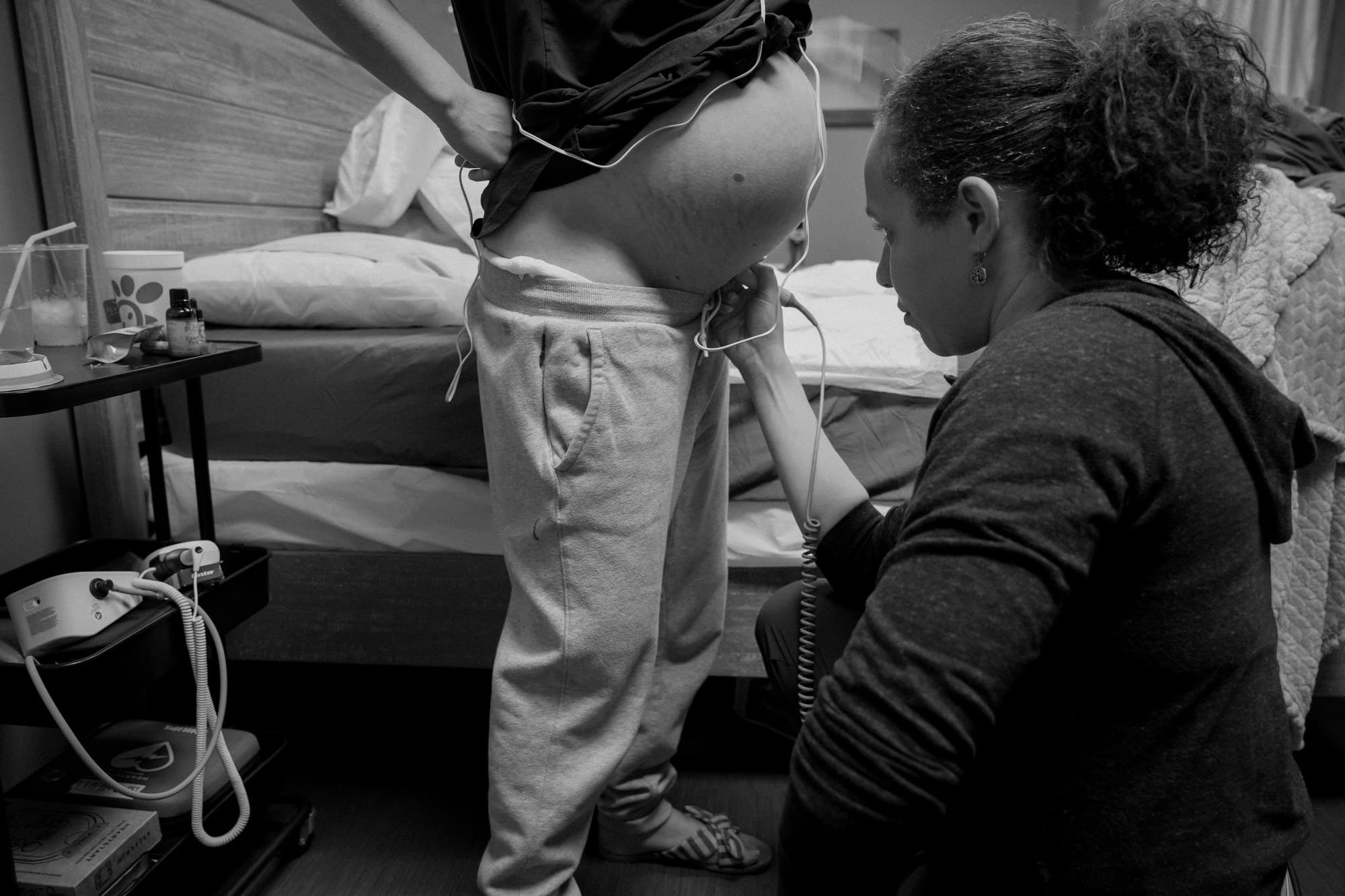 A midwife monitoring a laboring mother at Transitions Birth Center
